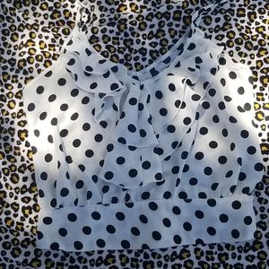 White with black polka dot sleeveless top.